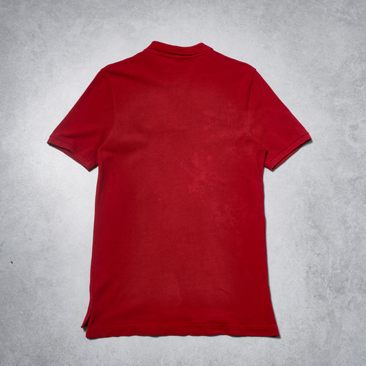 Red polo shirt on a gray textured background