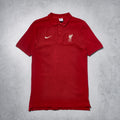 Red polo shirt with Nike and Liverpool FC logos on a gray background