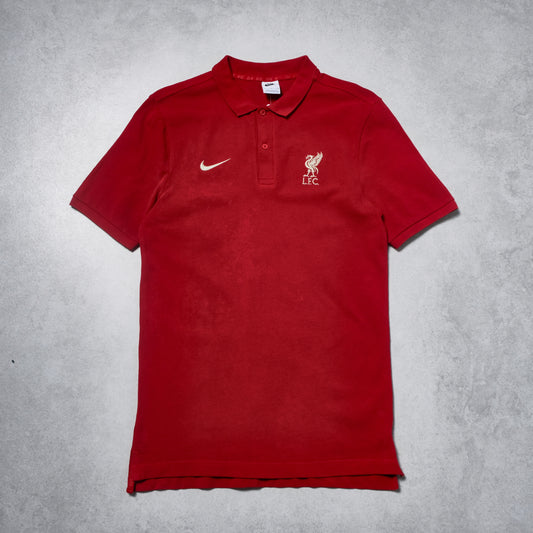 Red polo shirt with Nike and Liverpool FC logos on a gray background