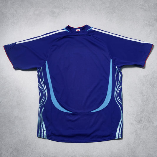Blue sports jersey with white and red accents on a gray background