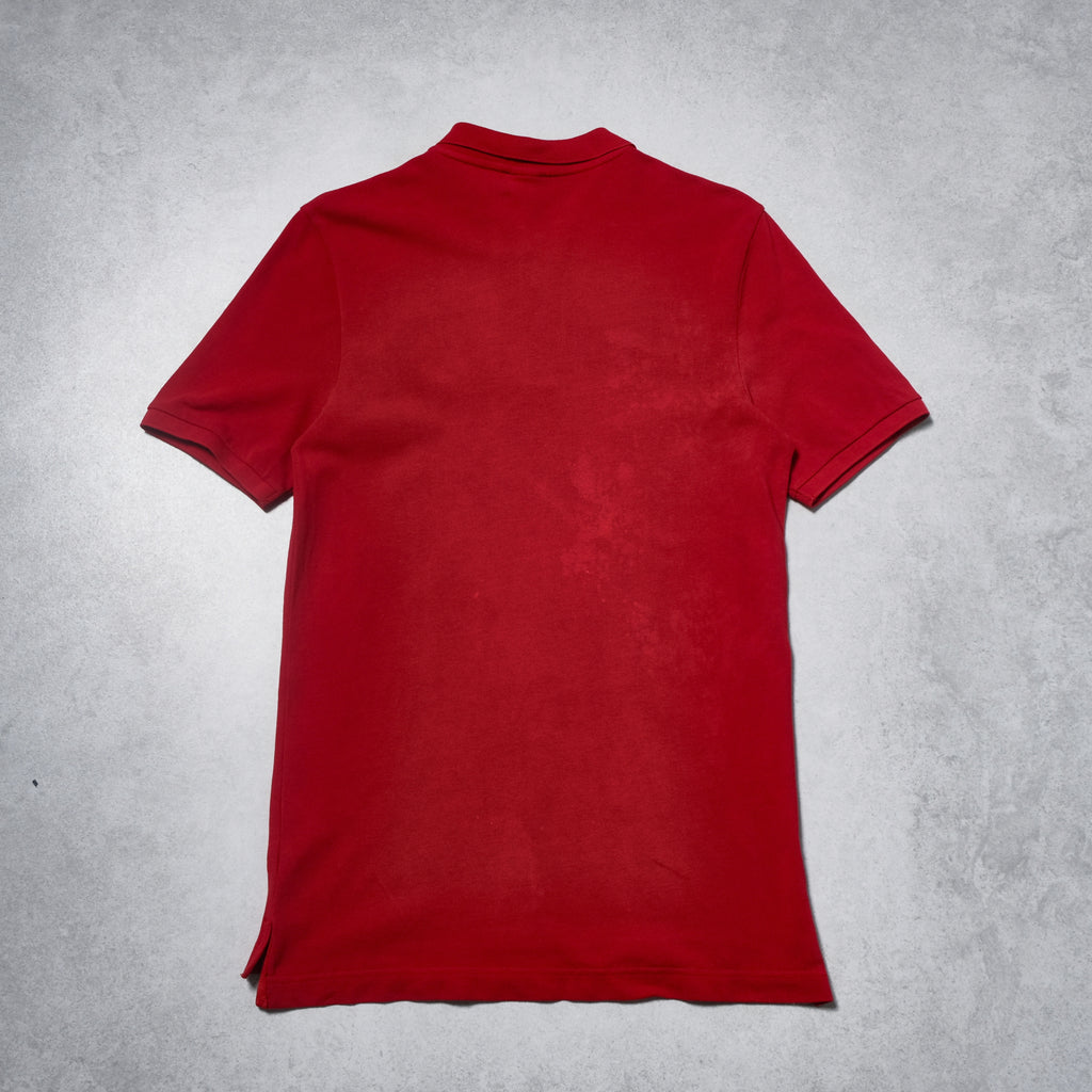 Red polo shirt on a gray textured background
