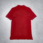 Red polo shirt on a gray textured background