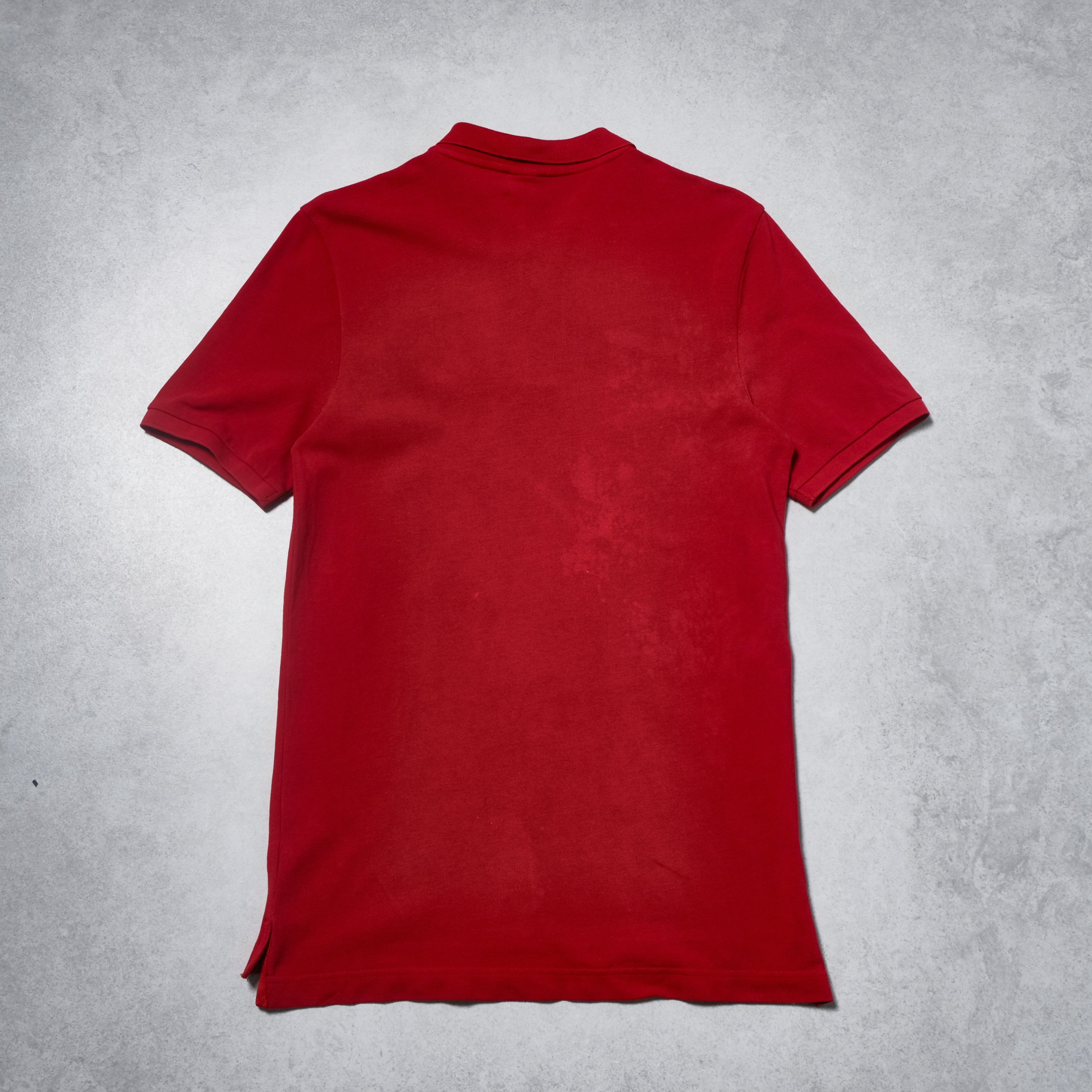Red polo shirt on a gray textured background