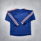 Blue sports jersey with red and white stripes on a gray background