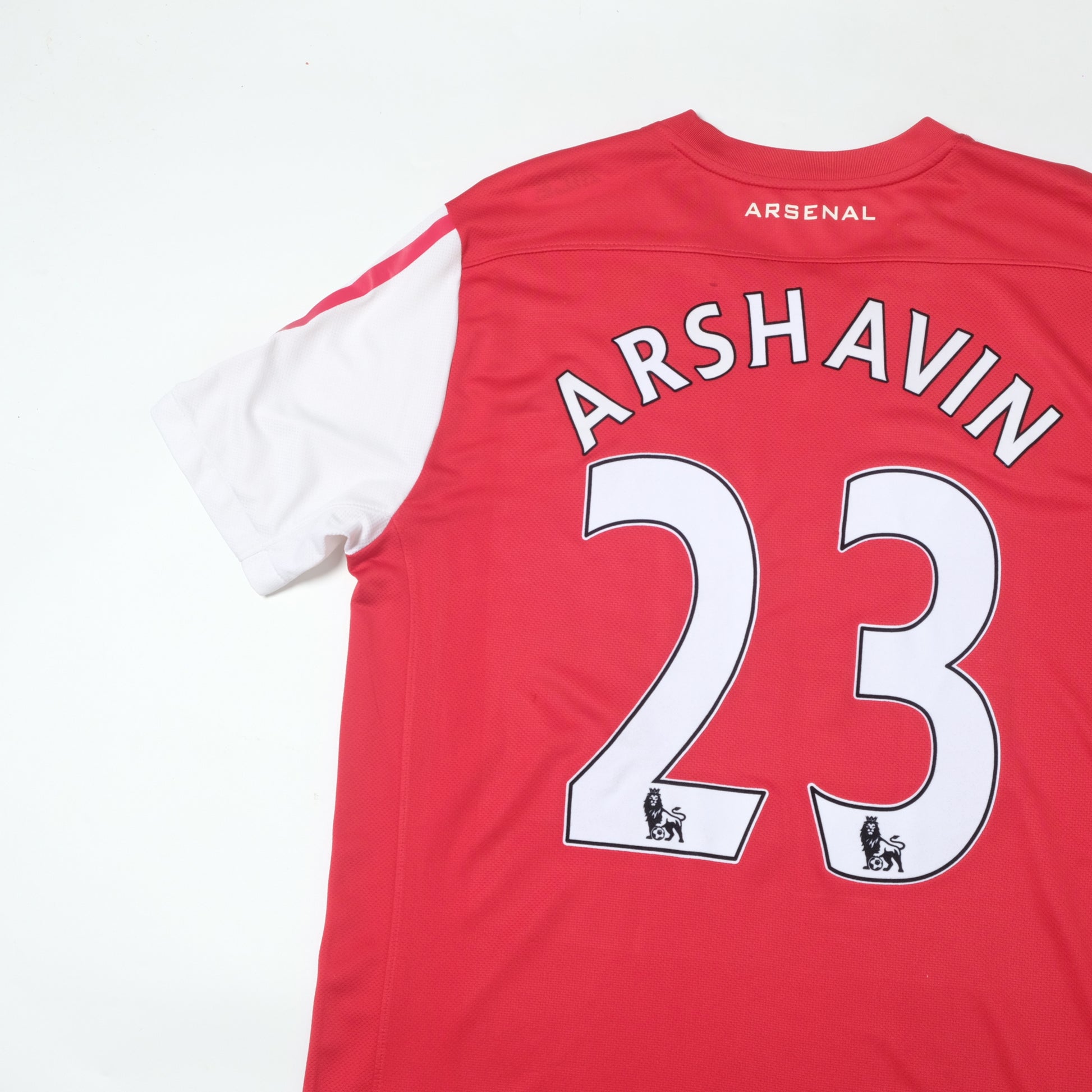 Red Arsenal football jersey with 'Arshavin' and number '23' on a white background