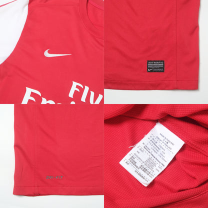 Red sports jersey with Nike logo and branding on a white background